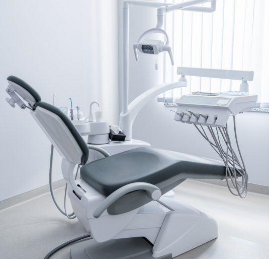 empty-dentist-office-with-chair-and-various-dental-equipment.jpg